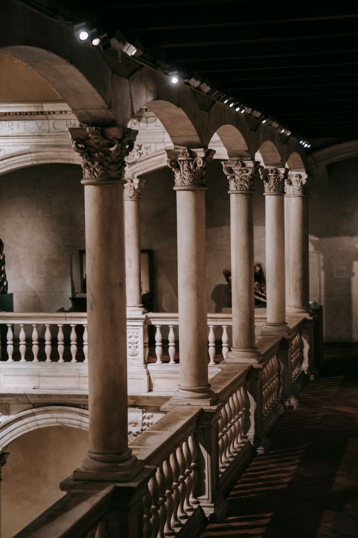 Classy interior design of majestic historic palace hallway with ornamental columns and decorative stucco elements